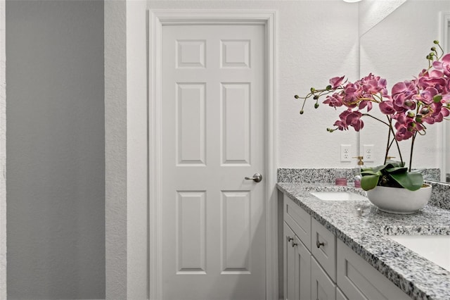 9131 Canter Path, Sebring, FL 33870 - full bathroom with double vanity and a textured wall