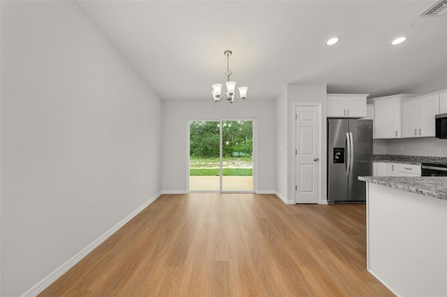 9131 Canter Path, Sebring, FL 33870 - kitchen featuring appliances with stainless steel finishes, light wood-type flooring, white cabinetry, a chandelier, and recessed lighting