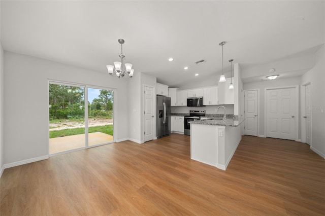 9131 Canter Path, Sebring, FL 33870 - kitchen featuring appliances with stainless steel finishes, a chandelier, a peninsula, white cabinets, and pendant lighting