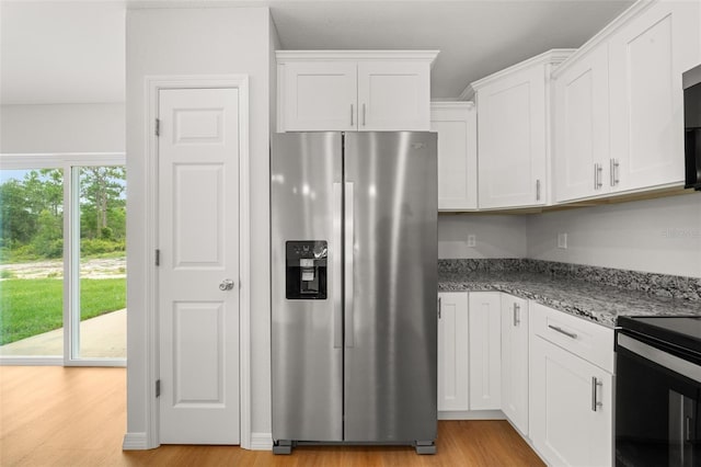 9131 Canter Path, Sebring, FL 33870 - kitchen featuring appliances with stainless steel finishes, white cabinetry, light wood-type flooring, and light stone countertops