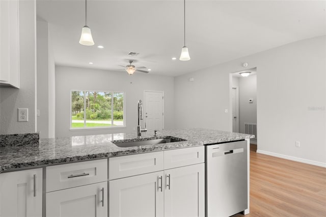 9131 Canter Path, Sebring, FL 33870 - kitchen featuring dishwasher, white cabinetry, light stone counters, recessed lighting, and light wood-style flooring