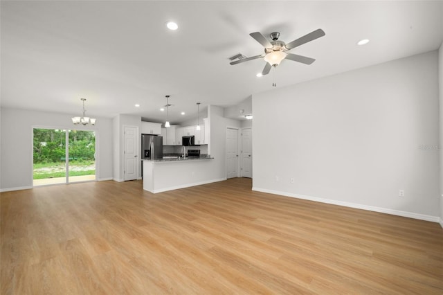 9131 Canter Path, Sebring, FL 33870 - unfurnished living room with a chandelier, recessed lighting, light wood-type flooring, and ceiling fan