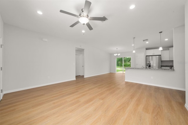 9131 Canter Path, Sebring, FL 33870 - unfurnished living room with a ceiling fan, a chandelier, light wood-style flooring, and recessed lighting
