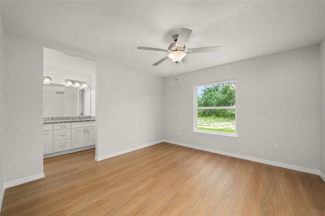 9131 Canter Path, Sebring, FL 33870 - unfurnished bedroom featuring light wood-style floors, connected bathroom, and ceiling fan