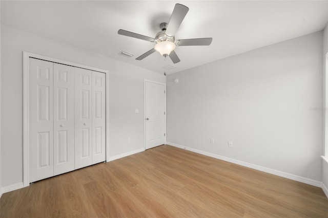 9131 Canter Path, Sebring, FL 33870 - unfurnished bedroom with light wood-style flooring, a closet, and a ceiling fan