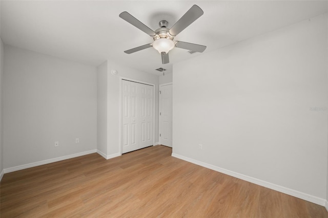 9131 Canter Path, Sebring, FL 33870 - unfurnished bedroom with light wood finished floors, a closet, and ceiling fan