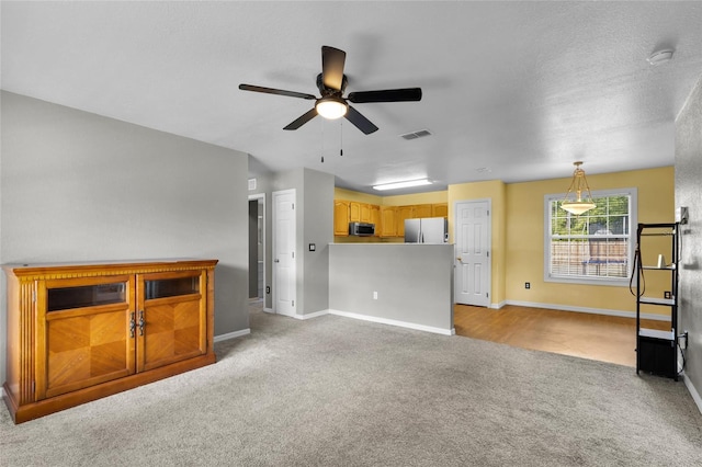 2263 Moines Ct, Dunnellon, FL 34431 - unfurnished living room featuring light carpet, a ceiling fan, and baseboards