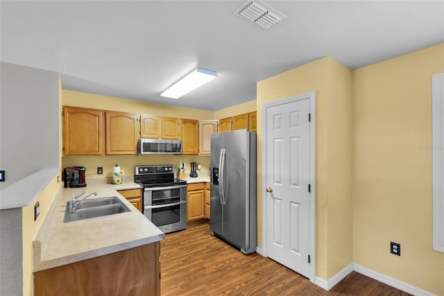 2263 Moines Ct, Dunnellon, FL 34431 - kitchen featuring appliances with stainless steel finishes, a sink, dark wood finished floors, light countertops, and baseboards