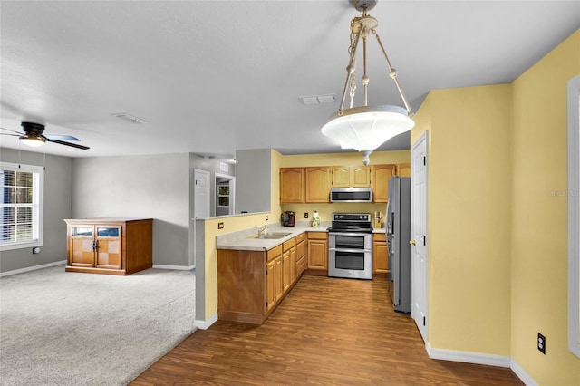 2263 Moines Ct, Dunnellon, FL 34431 - kitchen featuring stainless steel appliances, a sink, baseboards, light countertops, and dark wood-type flooring