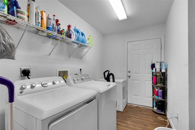 2263 Moines Ct, Dunnellon, FL 34431 - laundry area with washer and dryer, dark wood-style floors, a textured ceiling, and a textured wall