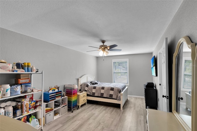 2263 Moines Ct, Dunnellon, FL 34431 - bedroom with multiple windows, light wood-style flooring, a textured ceiling, and ceiling fan
