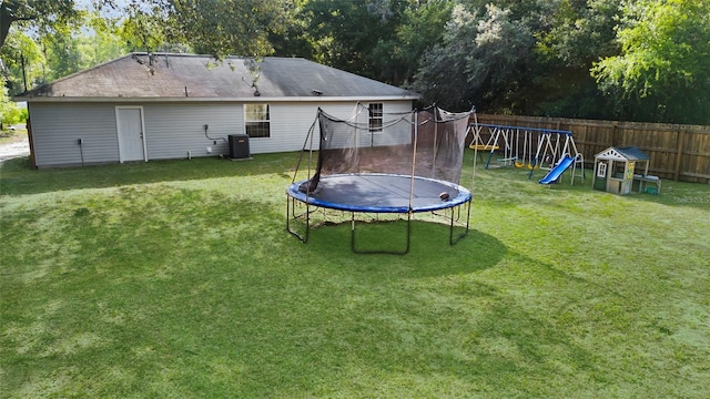 2263 Moines Ct, Dunnellon, FL 34431 - view of yard featuring a trampoline, central AC, and a playground