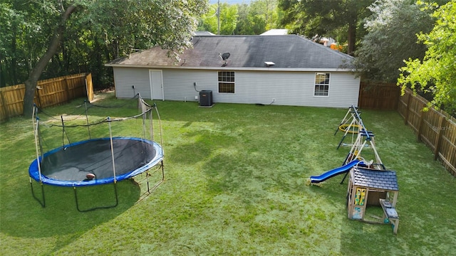 2263 Moines Ct, Dunnellon, FL 34431 - back of house with a trampoline and central air condition unit