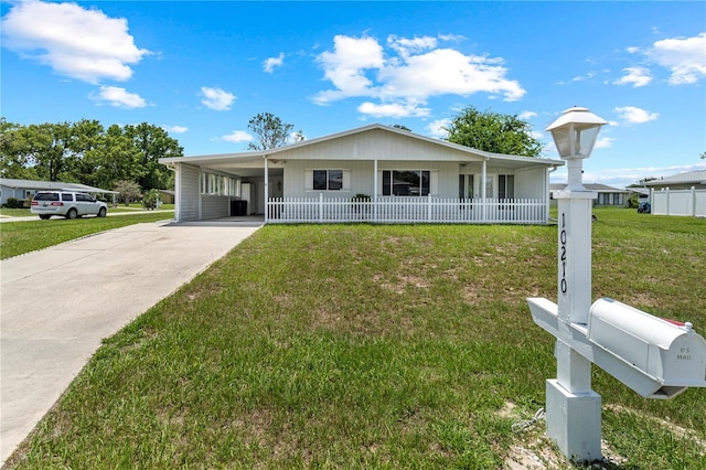 10210 SW 93rd Ave, Ocala, FL 34481 - ranch-style house with driveway, an attached carport, and covered porch