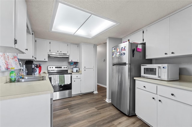 10210 SW 93rd Ave, Ocala, FL 34481 - kitchen with appliances with stainless steel finishes, under cabinet range hood, white cabinetry, light countertops, and a textured ceiling