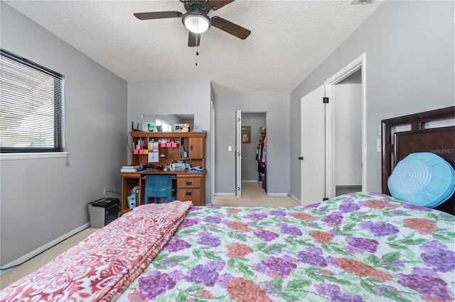 10210 SW 93rd Ave, Ocala, FL 34481 - carpeted bedroom with a textured ceiling, a walk in closet, ceiling fan, and a closet