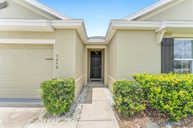 6646 SW 64th Ave, Ocala, FL 34476 - view of exterior entry with stucco siding and a garage