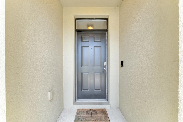 6646 SW 64th Ave, Ocala, FL 34476 - doorway to property featuring stucco siding