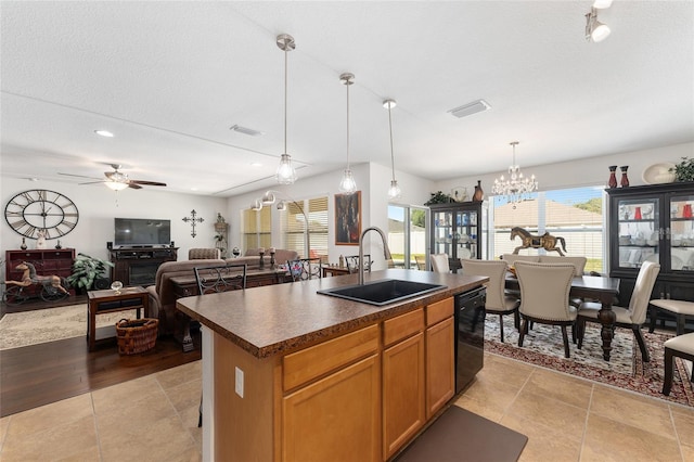 6646 SW 64th Ave, Ocala, FL 34476 - kitchen with dark countertops, dishwasher, a ceiling fan, a kitchen island with sink, and a chandelier
