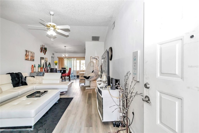 6127 SW 84th Place Rd, Ocala, FL 34476 - living room featuring ceiling fan, lofted ceiling, a textured ceiling, and light wood finished floors