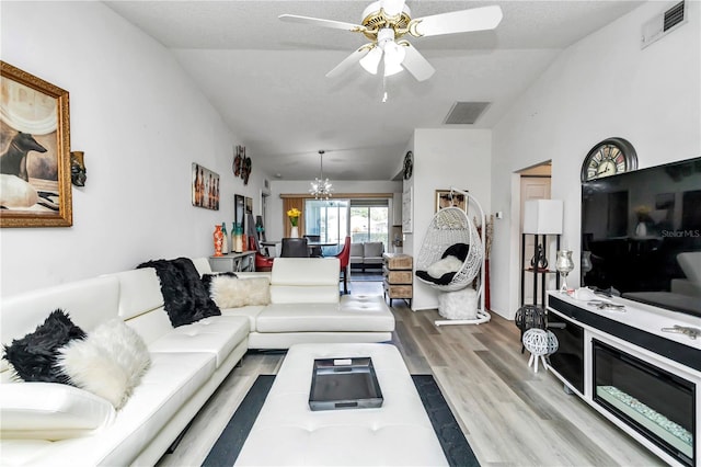 6127 SW 84th Place Rd, Ocala, FL 34476 - living area featuring lofted ceiling, wood finished floors, a chandelier, and ceiling fan