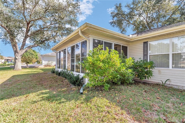 6127 SW 84th Place Rd, Ocala, FL 34476 - view of home's exterior featuring a sunroom and a lawn