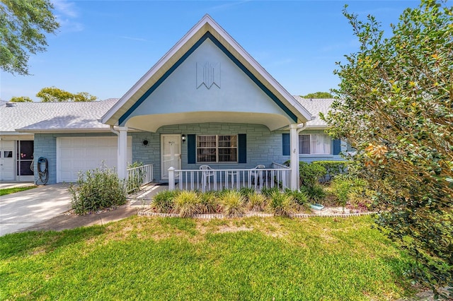 8431 SW 93rd Pl Unit F, Ocala, FL 34481 - view of front of property featuring a porch, a garage, a front lawn, and roof with shingles