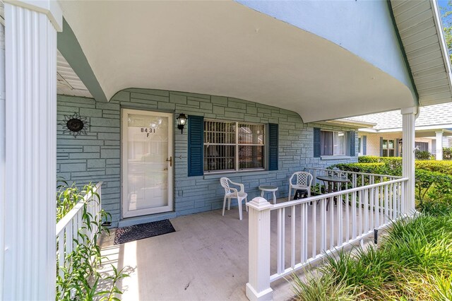 8431 SW 93rd Pl Unit F, Ocala, FL 34481 - property entrance featuring covered porch and stone siding