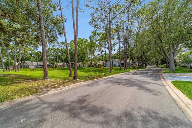 8431 SW 93rd Pl Unit F, Ocala, FL 34481 - view of asphalt street with curbs and a residential view