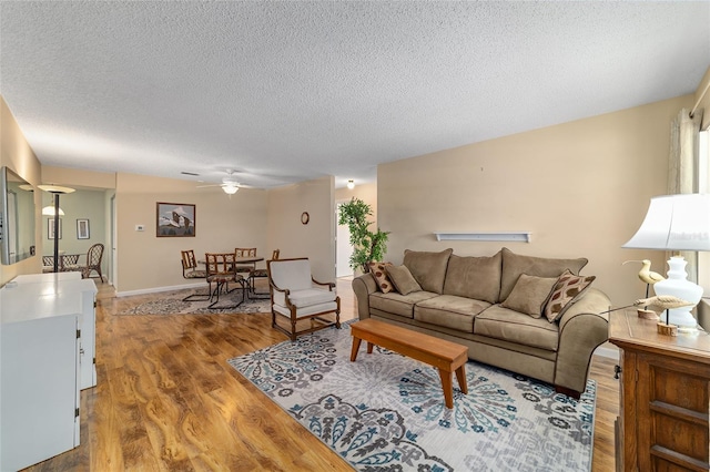 8431 SW 93rd Pl Unit F, Ocala, FL 34481 - living area featuring a ceiling fan, light wood-style flooring, and a textured ceiling