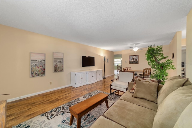 8431 SW 93rd Pl Unit F, Ocala, FL 34481 - living area featuring ceiling fan, light wood-style flooring, baseboards, and a textured ceiling