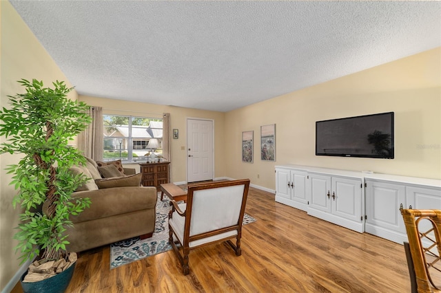 8431 SW 93rd Pl Unit F, Ocala, FL 34481 - living area featuring a textured ceiling, light wood-style floors, and baseboards