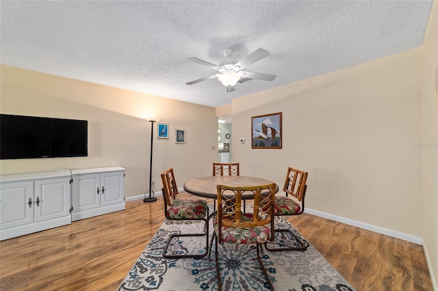 8431 SW 93rd Pl Unit F, Ocala, FL 34481 - dining space featuring ceiling fan, a textured ceiling, light wood finished floors, and baseboards