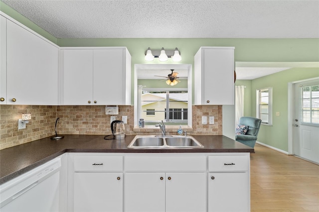 8431 SW 93rd Pl Unit F, Ocala, FL 34481 - kitchen featuring a sink, white dishwasher, dark countertops, a ceiling fan, and a textured ceiling