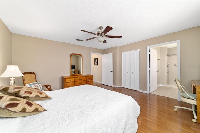 8431 SW 93rd Pl Unit F, Ocala, FL 34481 - bedroom featuring wood finished floors, a ceiling fan, baseboards, ensuite bathroom, and a closet