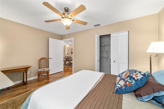8431 SW 93rd Pl Unit F, Ocala, FL 34481 - bedroom featuring wood finished floors, a closet, a ceiling fan, and baseboards