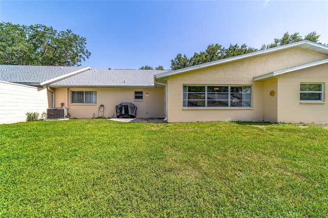 8431 SW 93rd Pl Unit F, Ocala, FL 34481 - rear view of house with central AC and a lawn