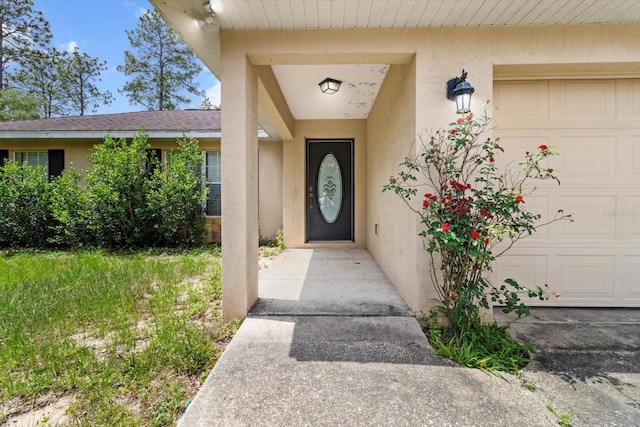 23340 NW Columbine Ave, Dunnellon, FL 34431 - doorway to property featuring stucco siding and an attached garage
