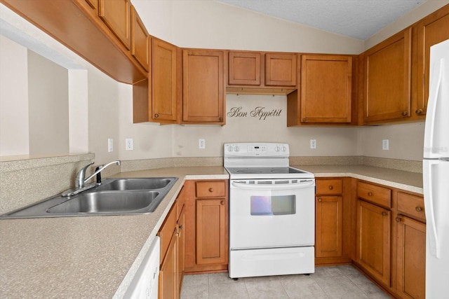 23340 NW Columbine Ave, Dunnellon, FL 34431 - kitchen with white appliances, brown cabinets, light tile patterned floors, light countertops, and vaulted ceiling