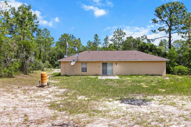 23340 NW Columbine Ave, Dunnellon, FL 34431 - back of property featuring a lawn and stucco siding