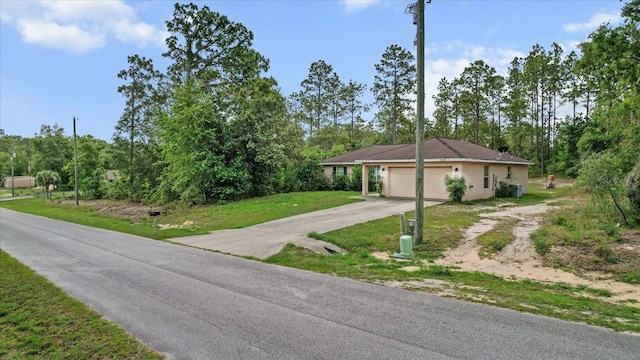 23340 NW Columbine Ave, Dunnellon, FL 34431 - ranch-style home featuring concrete driveway, view of wooded area, and a front lawn
