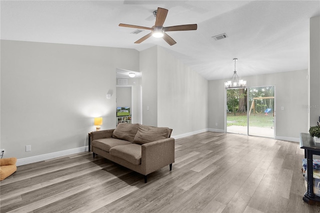 18 Banyan Pass, Ocala, FL 34472 - living area with wood finished floors, ceiling fan, vaulted ceiling, baseboards, and a chandelier