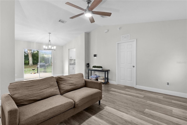 18 Banyan Pass, Ocala, FL 34472 - living room with vaulted ceiling, a ceiling fan, baseboards, a chandelier, and light wood-style floors