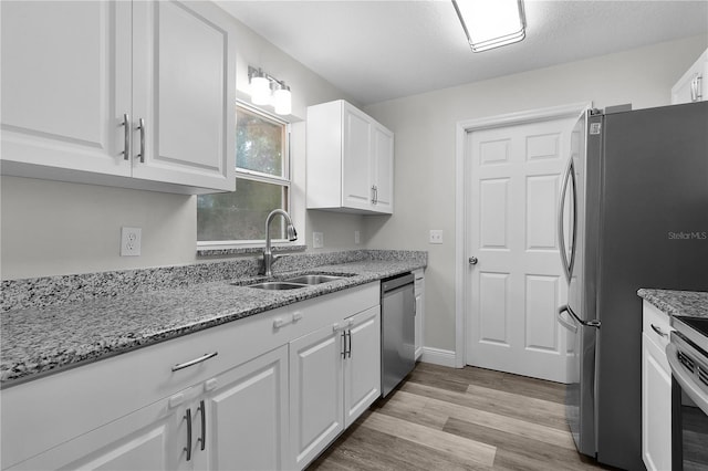 18 Banyan Pass, Ocala, FL 34472 - kitchen featuring appliances with stainless steel finishes, a sink, white cabinetry, and light stone countertops