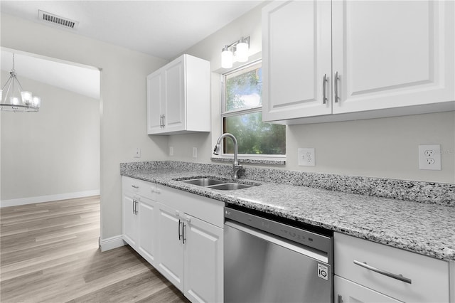 18 Banyan Pass, Ocala, FL 34472 - kitchen with dishwasher, a sink, white cabinetry, a chandelier, and light wood-style flooring