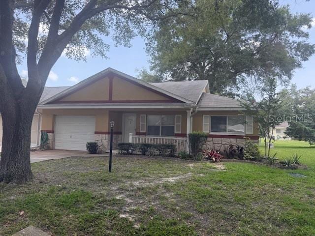9722 SW 95th Ct Unit C, Ocala, FL 34481 - view of front facade featuring a porch, stone siding, a front lawn, a garage, and driveway