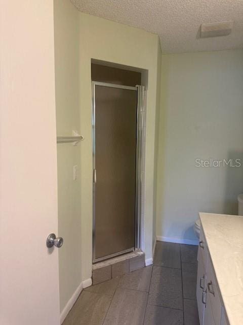 9722 SW 95th Ct Unit C, Ocala, FL 34481 - full bathroom with a stall shower, vanity, and a textured ceiling