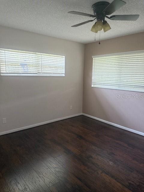 9722 SW 95th Ct Unit C, Ocala, FL 34481 - empty room featuring dark wood finished floors, plenty of natural light, a textured ceiling, and ceiling fan