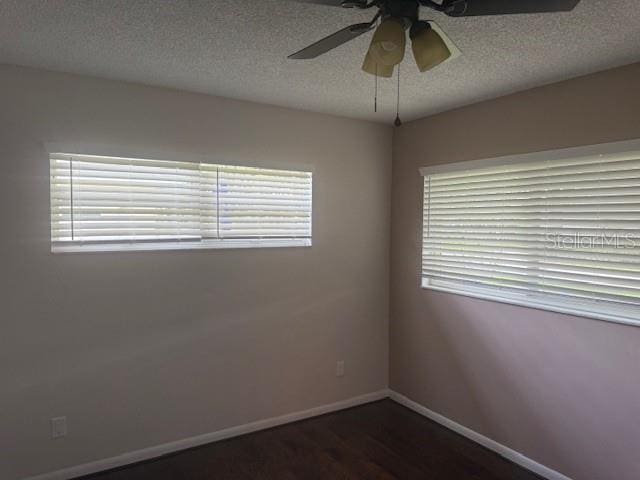 9722 SW 95th Ct Unit C, Ocala, FL 34481 - unfurnished room with a ceiling fan, a textured ceiling, plenty of natural light, and dark wood finished floors