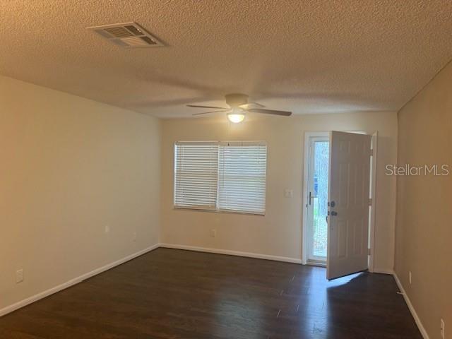 9722 SW 95th Ct Unit C, Ocala, FL 34481 - foyer entrance with dark wood-style flooring, ceiling fan, and a textured ceiling
